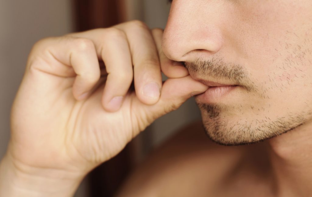 Man biting his nails.